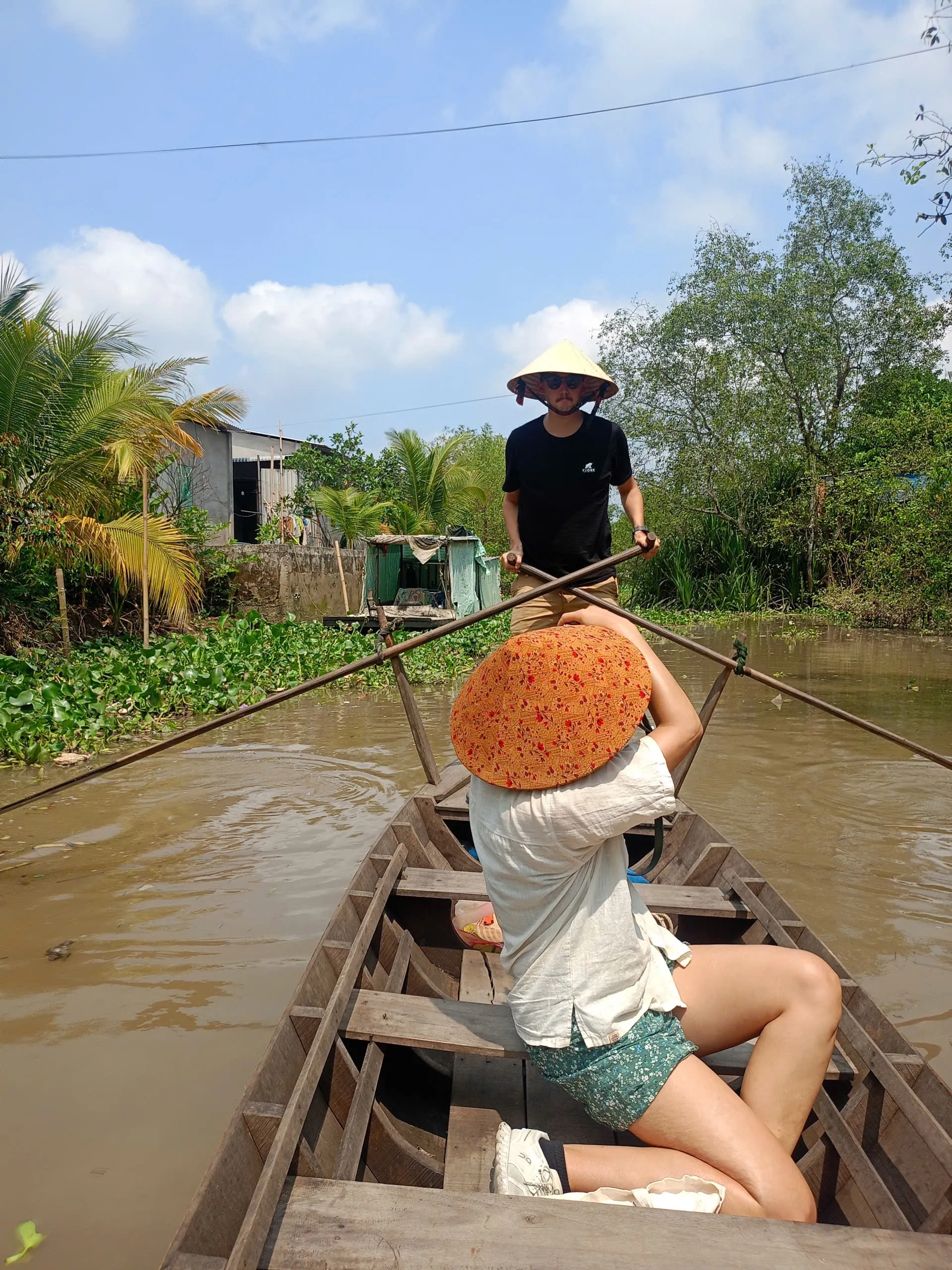 View from inside a rowing boat on a small canal in the Mekong Delta