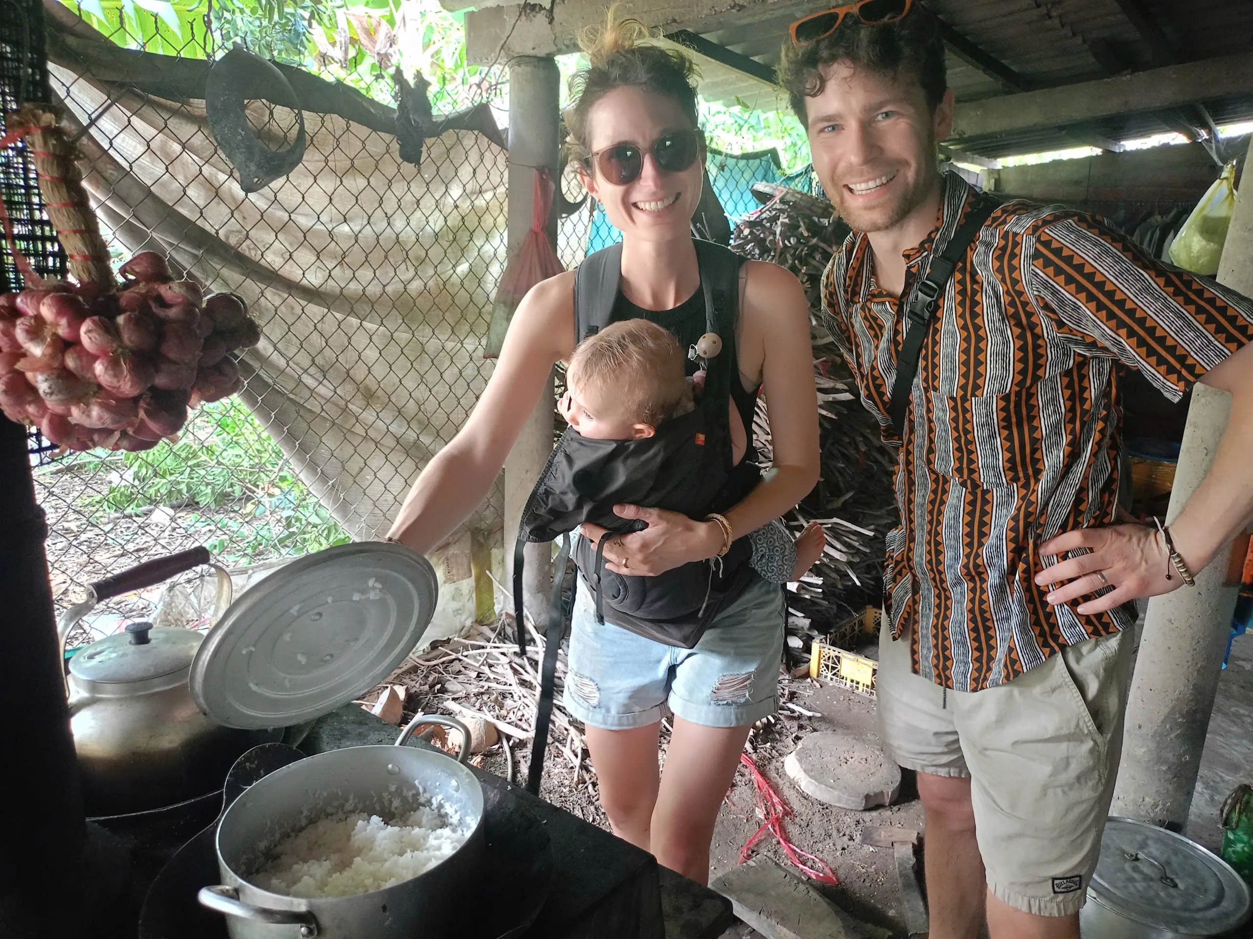 Young family exploring a local cooking spot in the Mekong Delta countryside
