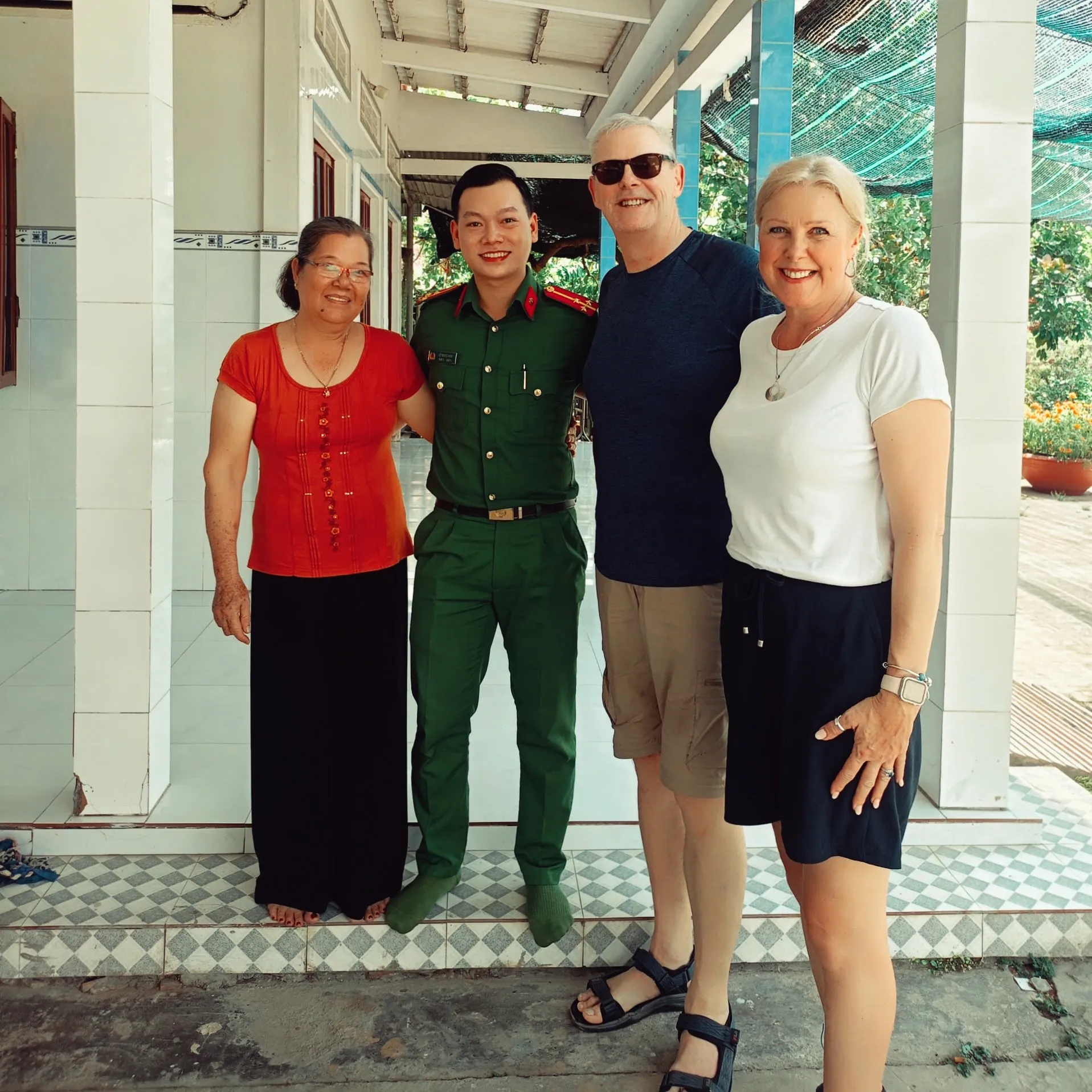 Visitors posing with a local family in Vinh Long countryside