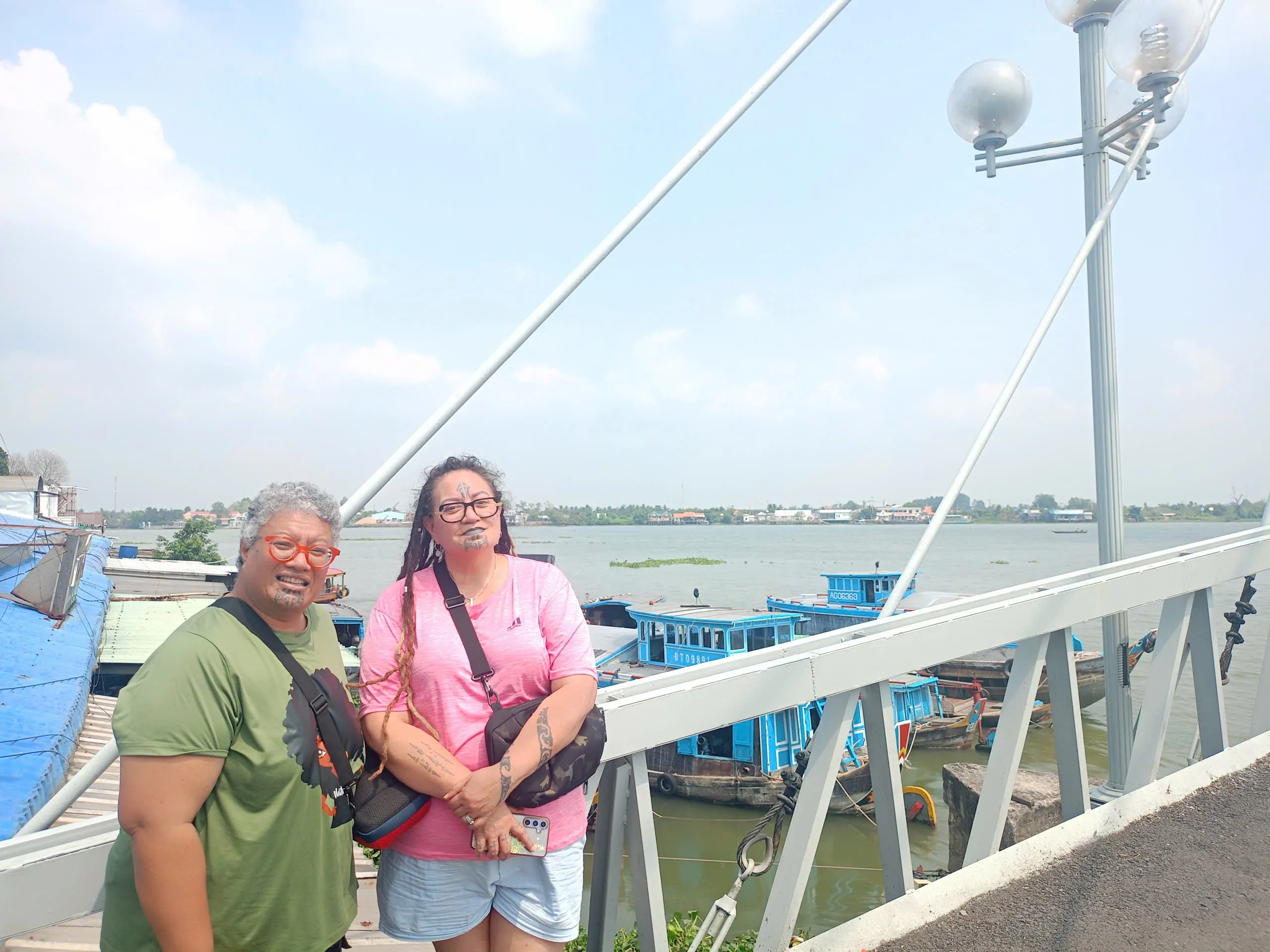 Travelers at a riverside dock on the Mekong River in Vinh Long