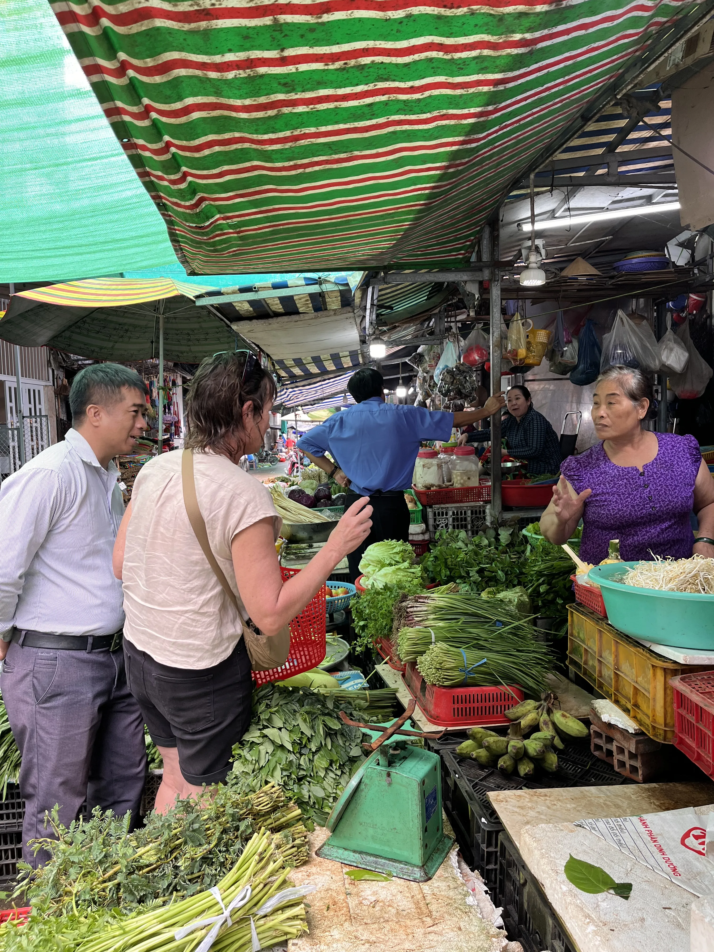 Traveler shopping for fresh vegetables at a Vinh Long market