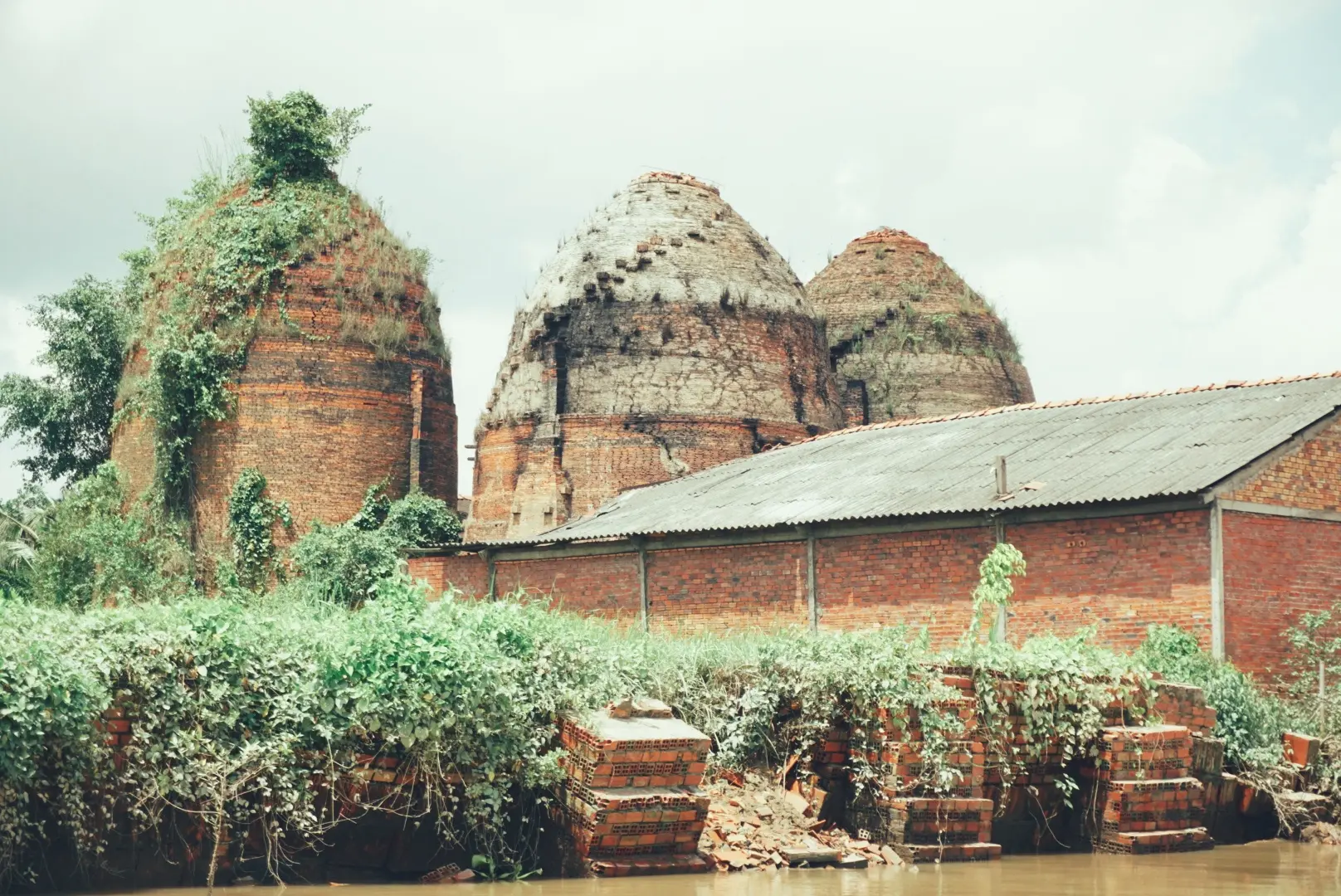 Traditional brick kilns beside a canal in Mang Thit pottery village, Vinh Long