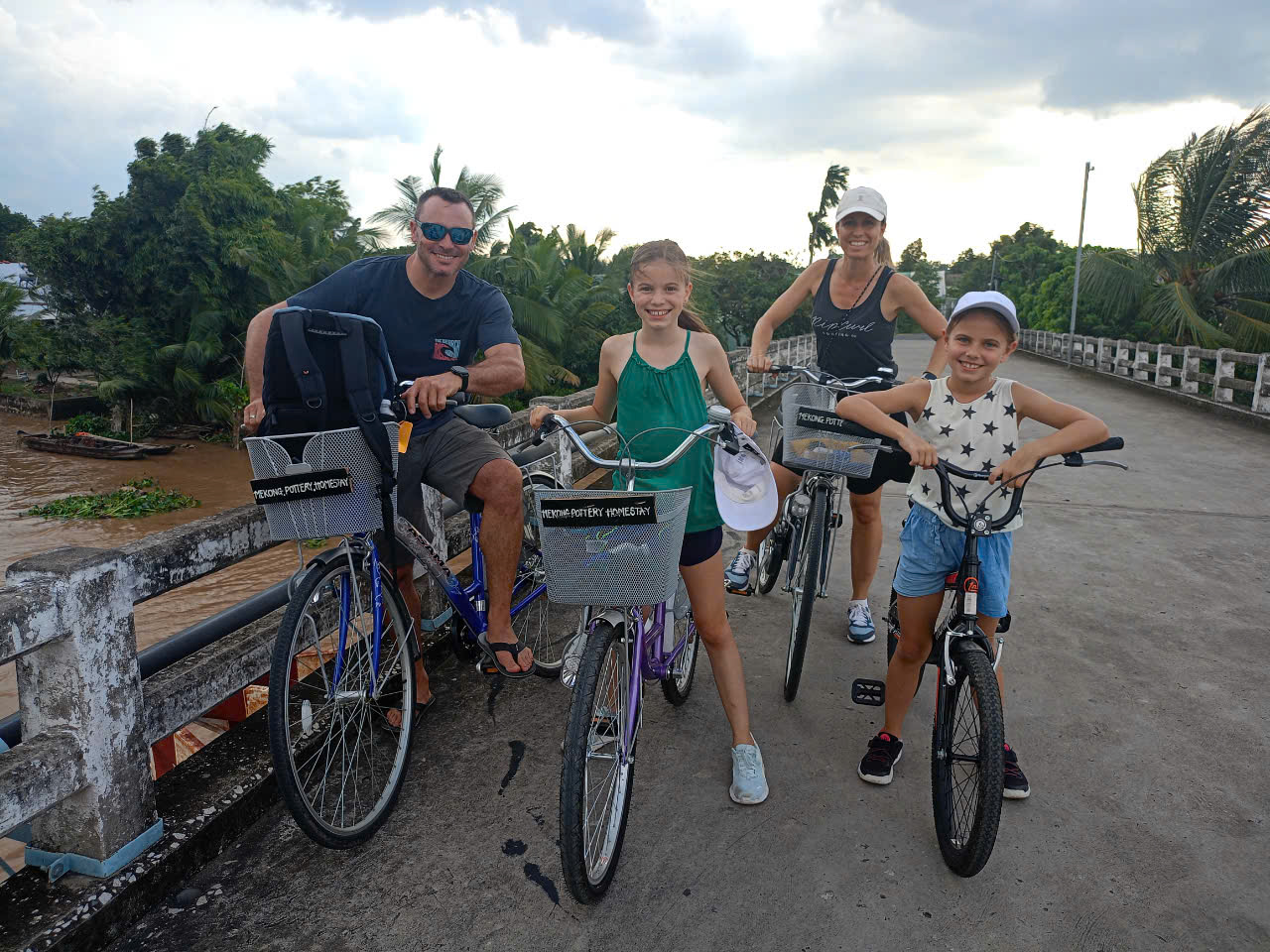 Family cycling on bridge