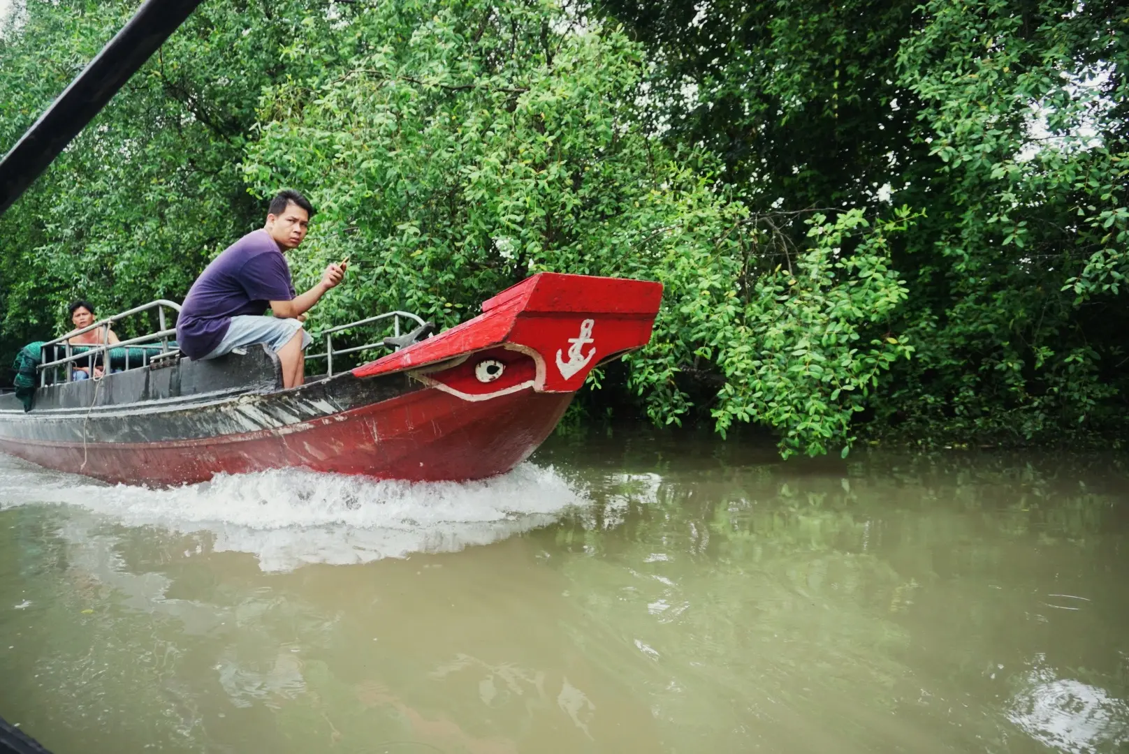 Red motorboat in channel