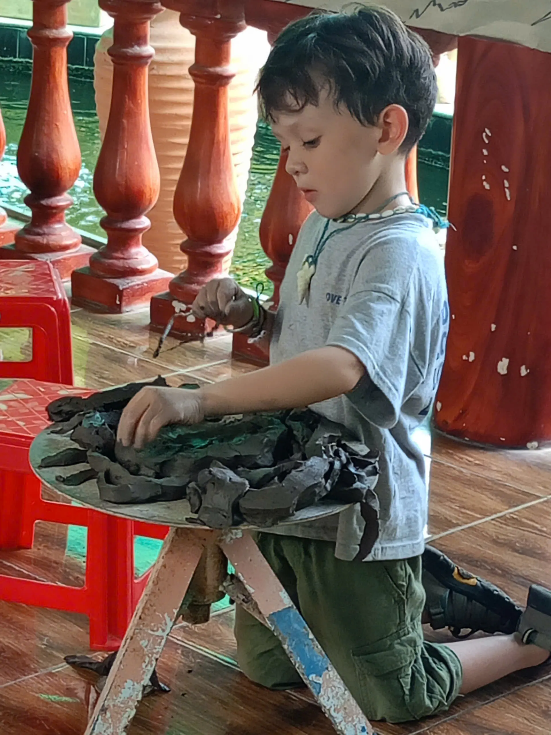 Child learning pottery