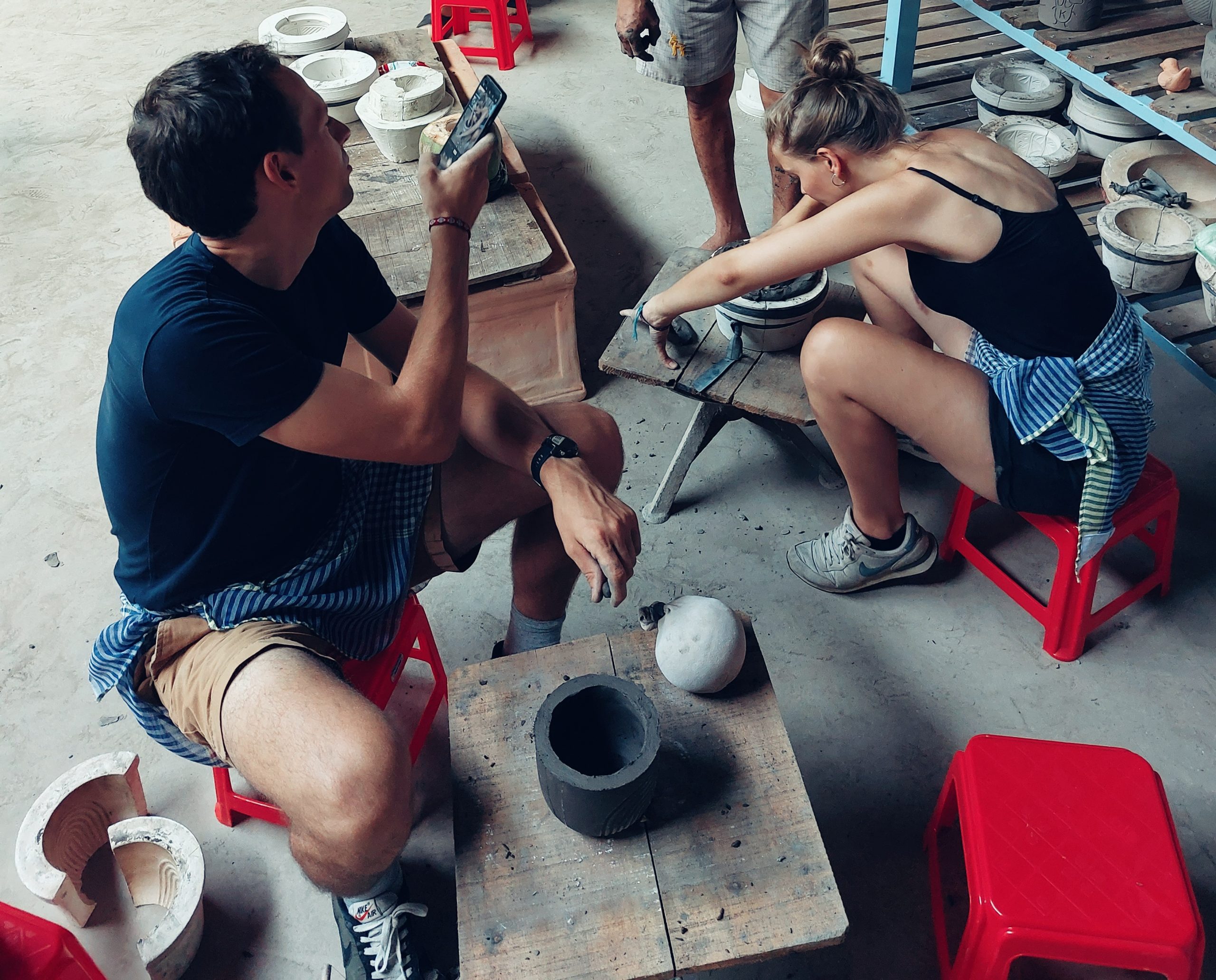 Couple making pottery together